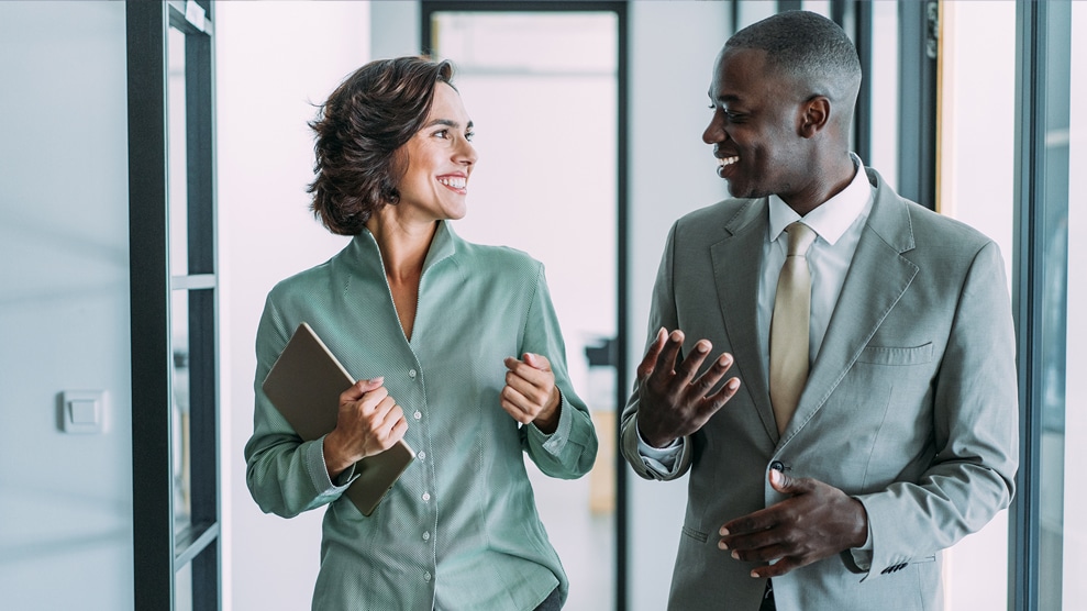 man and woman conversing in an office setting