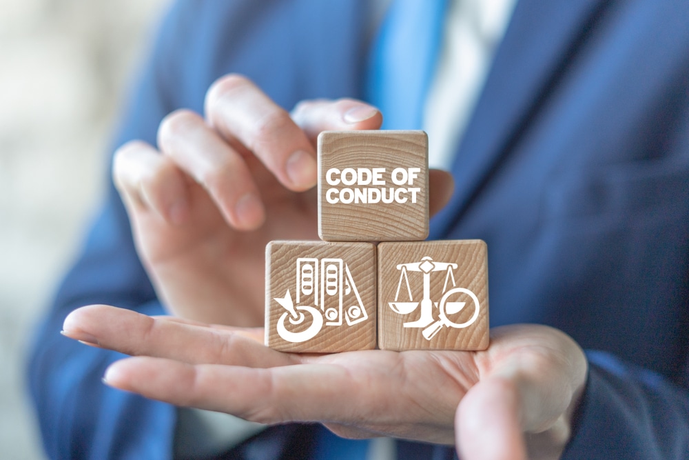 Code,Of,Conduct,Business,Concept,On,Wooden,Blocks,In,Businessman