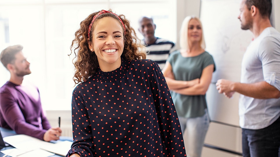 Smiling young designer standing in an office after a meeting