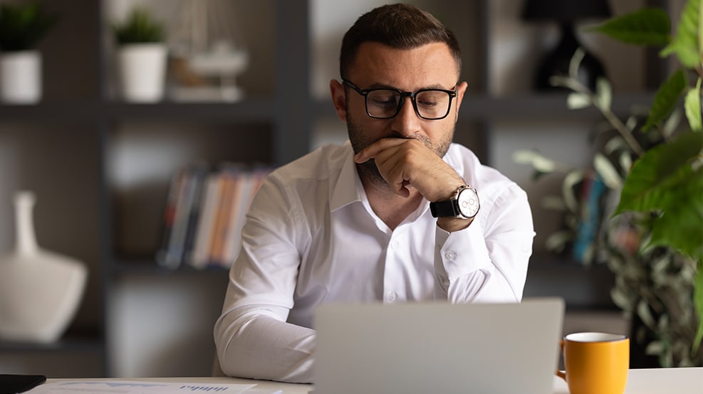 man looking at computer pensively