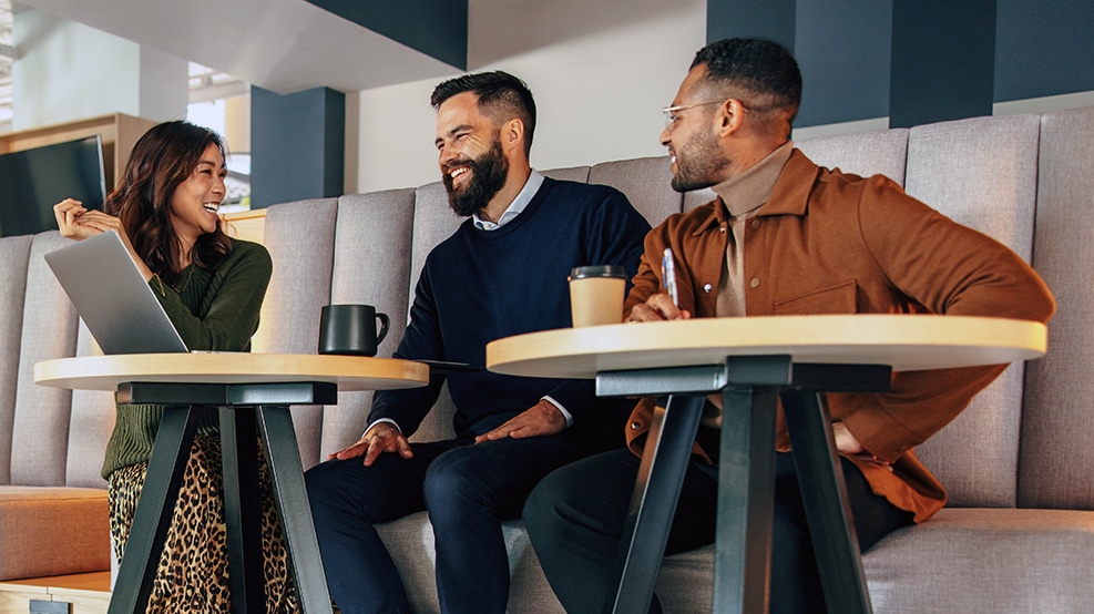 coworkers gathered around a desk